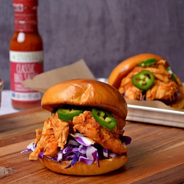 pulled chicken sandwich on a cutting board.