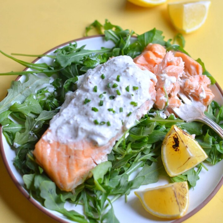 plate of mediterranean salmon on greens.