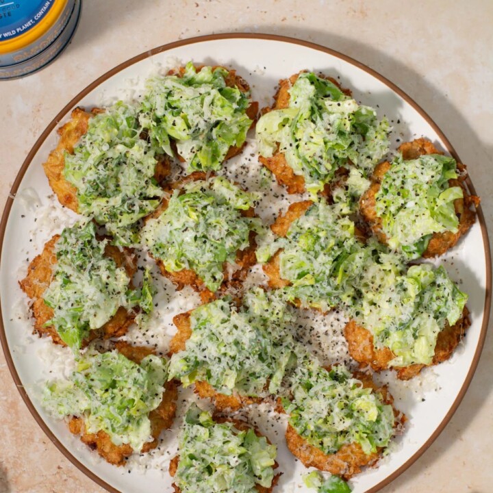 plate with several pieces of tuna caesar crostini.