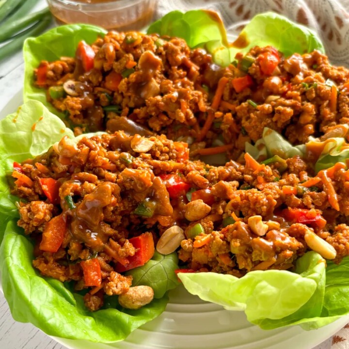 4 thai turkey lettuce wraps on a serving plate.