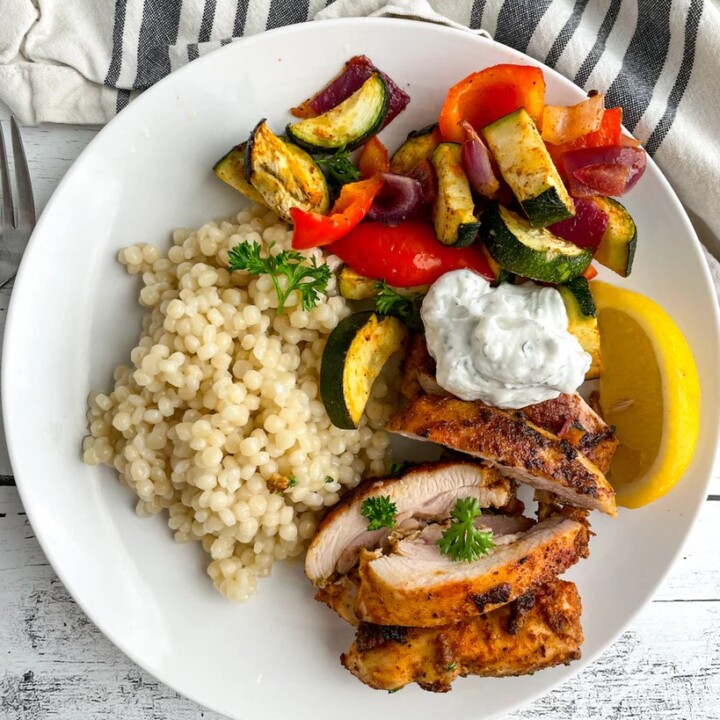 a plate of chicken shawarma and vegetables.