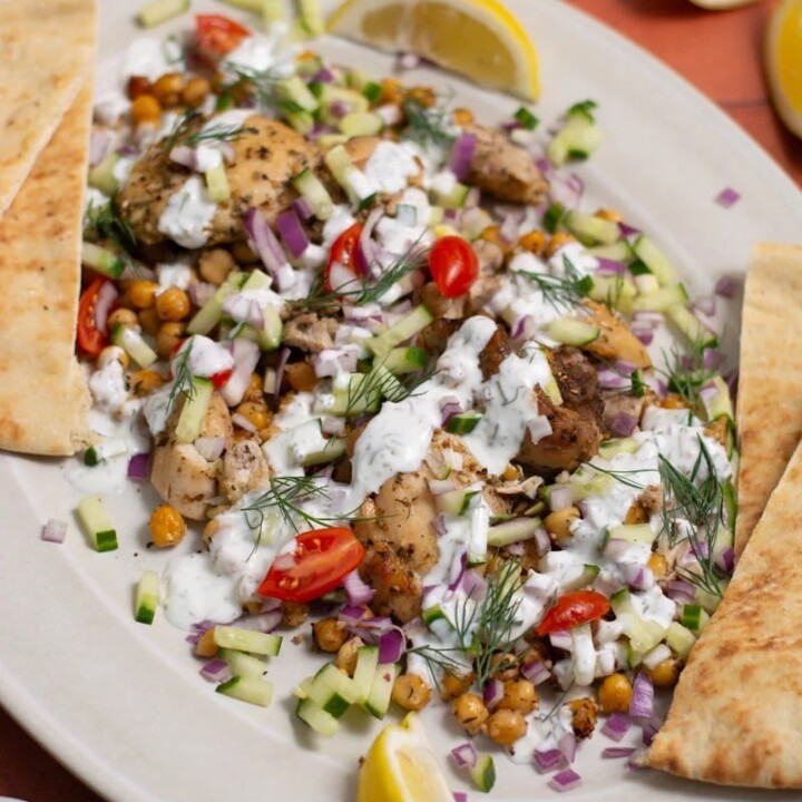 plate with a portion of sheet pan gyros and pita bread.
