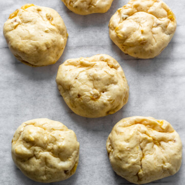banana protein cookies on parchment on a cooling rack.