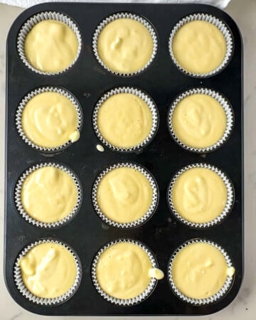 unbaked mini protein cheesecakes in a muffin tin.