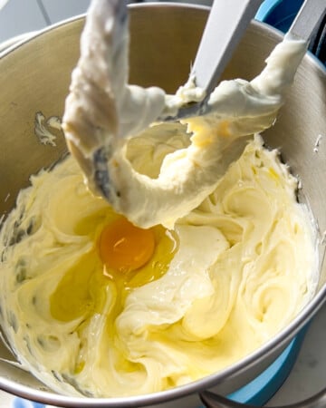 eggs going into the cheesecake batter.