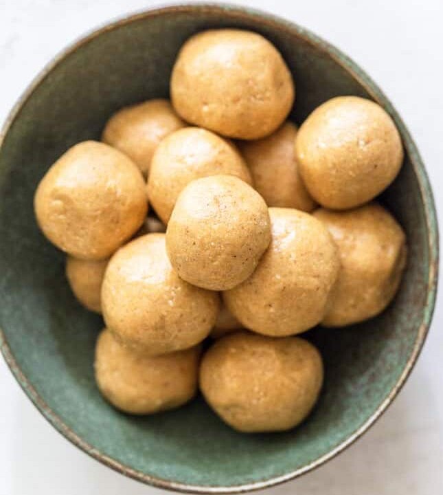 smooth peanut butter protein balls in a bowl.