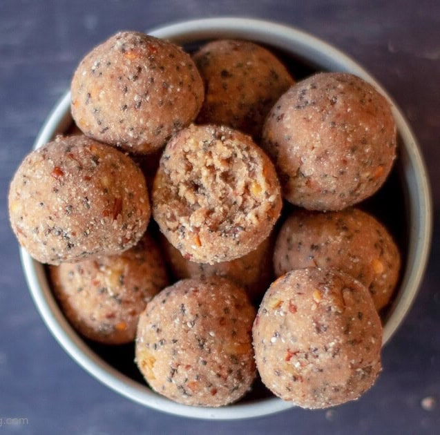 bowl of protein balls with nuts and chia seeds.