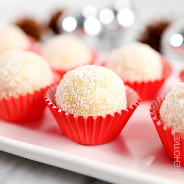 coconut protein balls in red paper candy cups.