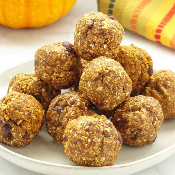 pumpkin and oat protein balls piled on a plate.