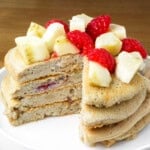 stack of banana berry protein pancakes on a plate.