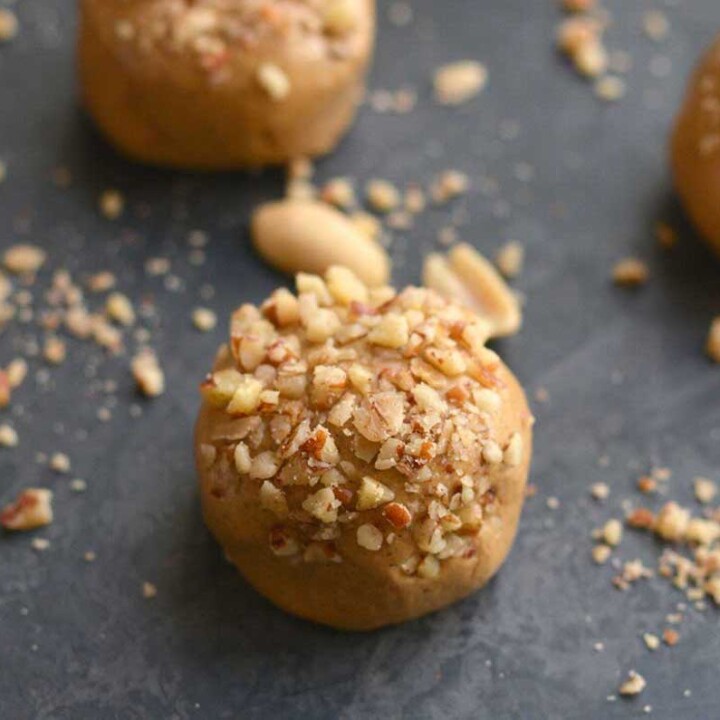 peanut butter protein balls topped with crushed peanuts.