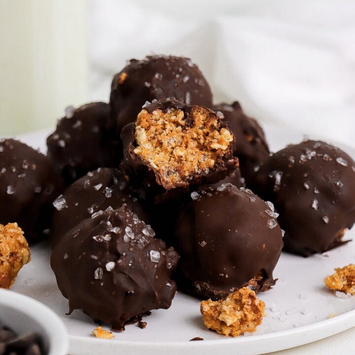 chocolate coated peanut butter crunch protein balls on a plate.