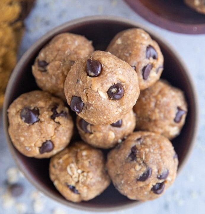 peanut butter oatmeal chocolate chip protein balls in a bowl.