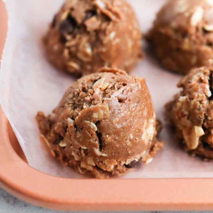 scooped protein balls on a parchment-lined tray.