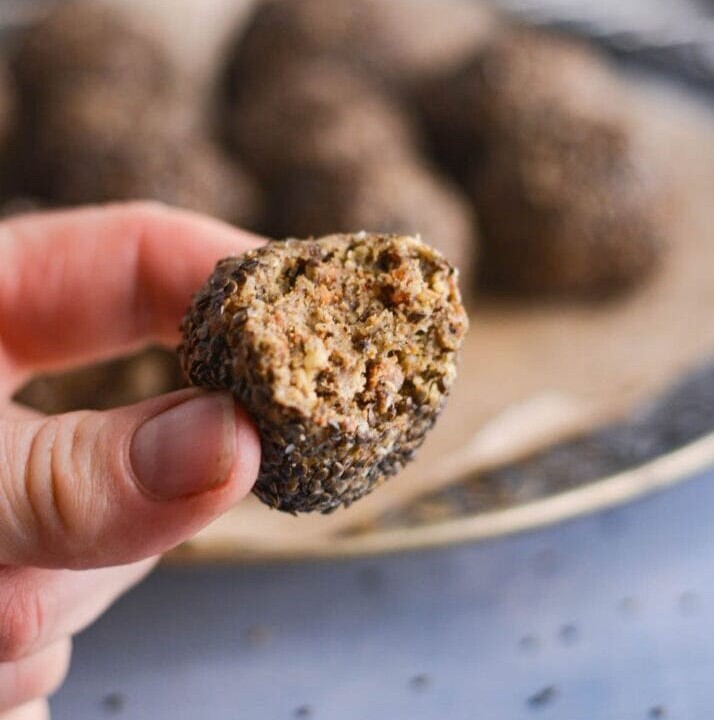 protein ball in hand and coated with nettle seeds.