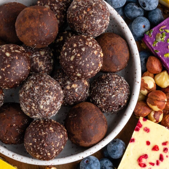 bowl of chocolate vegan protein balls with various coatings.