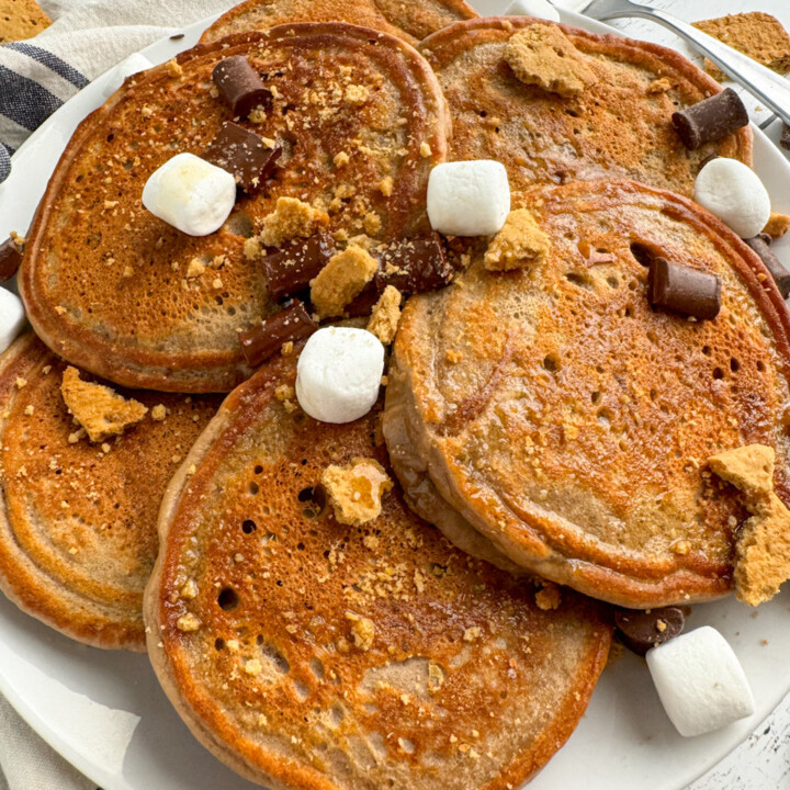 plated protein pancakes with marshmallows, chocolate pieces, and graham cracker pieces.