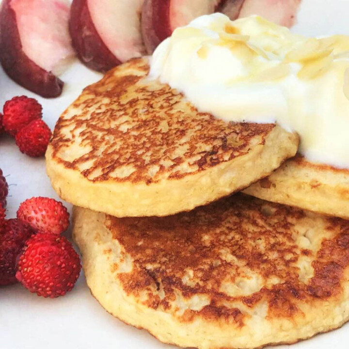 cottage cheese pancakes with fruit and cream topping.