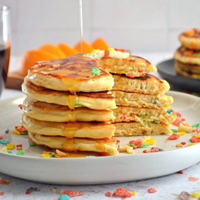 cut stack of fruity pebbels protein pancakes.