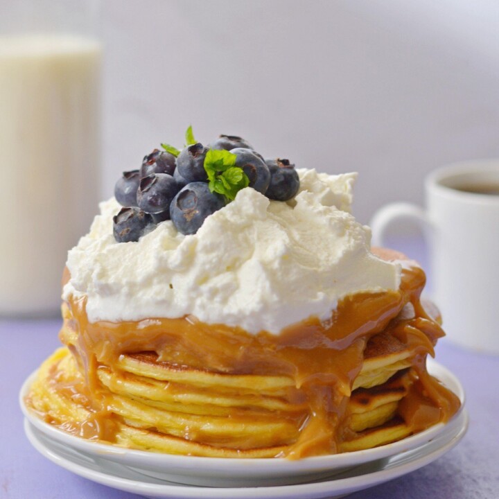 stack of protein pancakes with caramel and whipped cream.