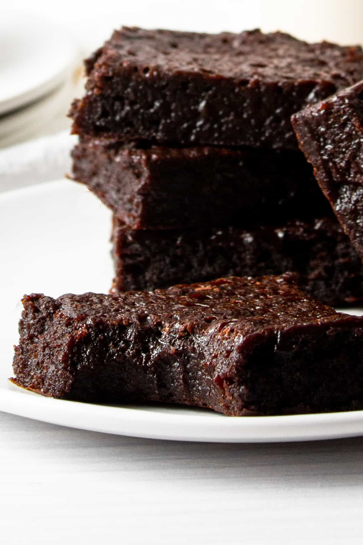 one bitten collagen protein brownie in front of other brownies.