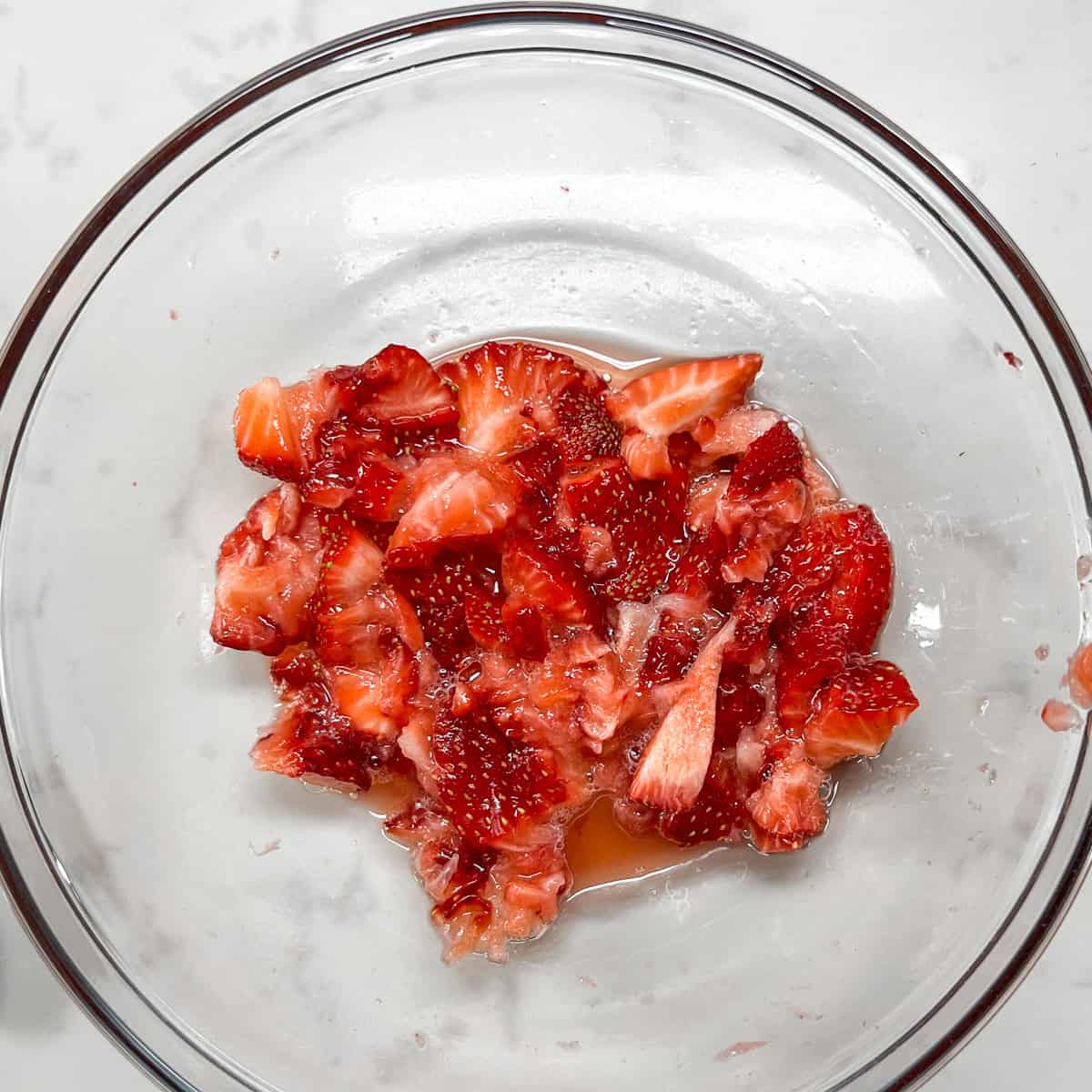 mashed strawberries in a glass bowl.