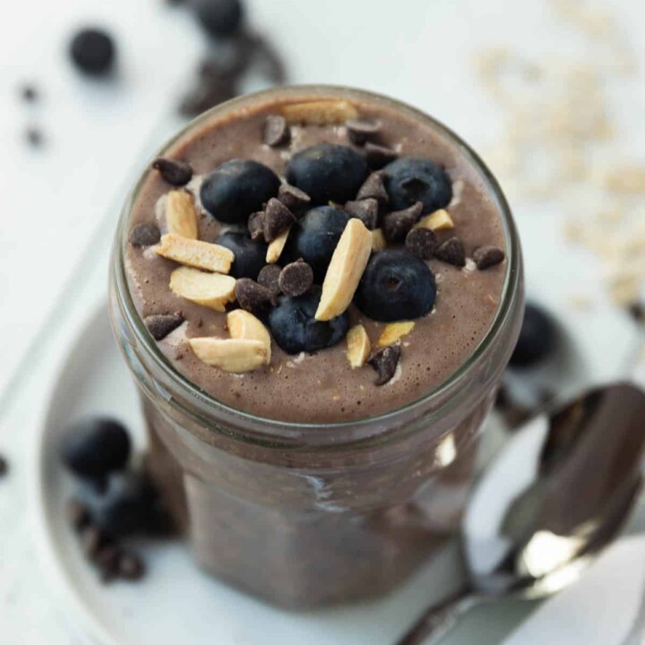 chocolate protein overnight oats in a jar with berries.