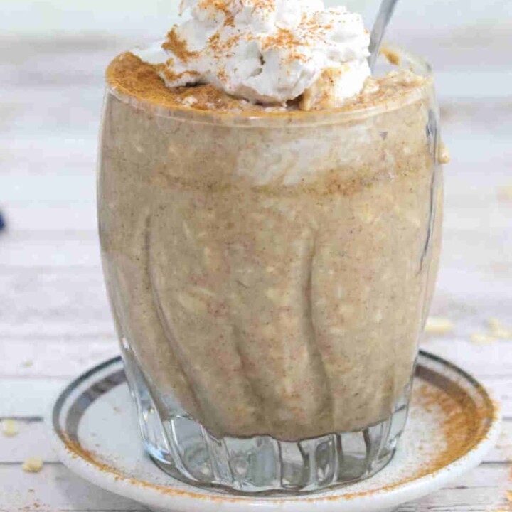 cinnamon roll overnight protein oats in a serving glass.