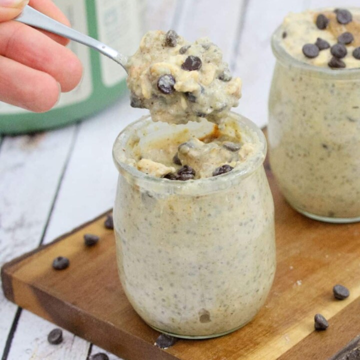 a spoonful of cookie dough overnight protein oats being pulled from the jar.