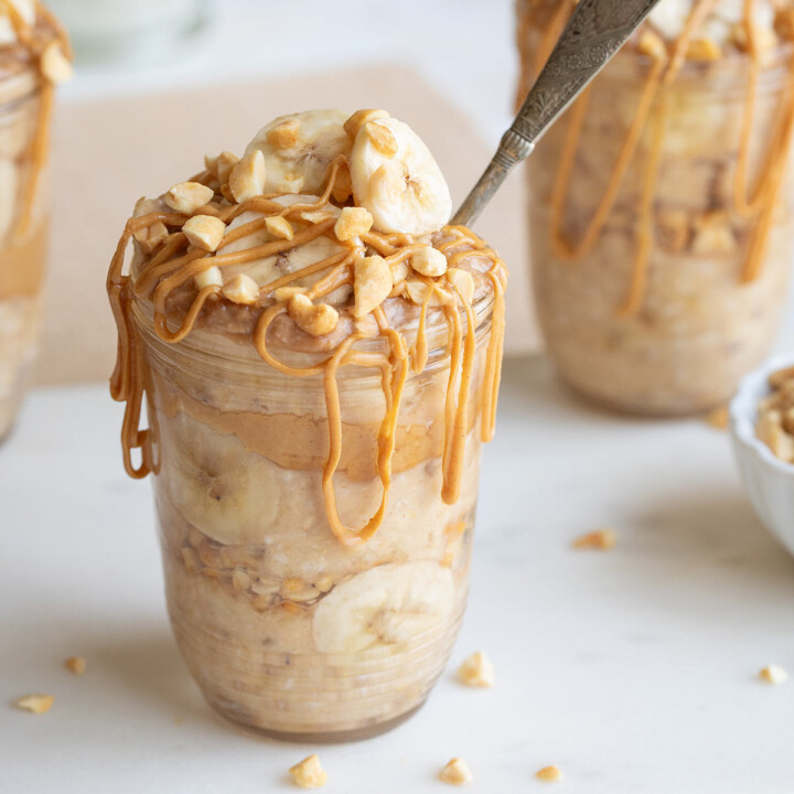 three jars of overnight protein oats with bananas and peanut butter.
