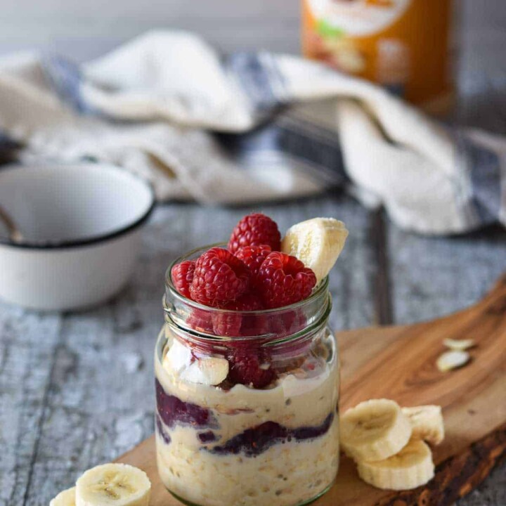 small jar of overnight oats with raspberries.