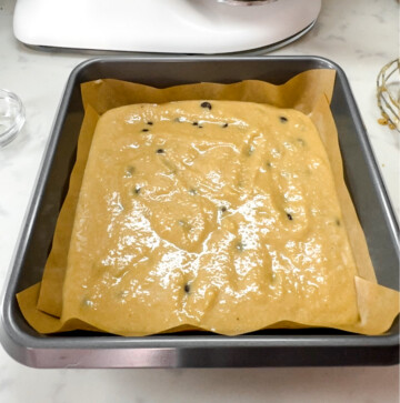 unbaked chocolate chip protein blondies in a parchment-lined pan.