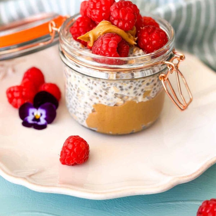 peanut butter and raspberry overnight protein oats in a small jar.