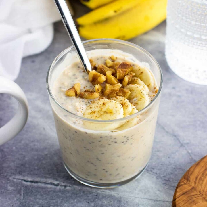overnight protein oats with banana and walnuts in a small glass dish.