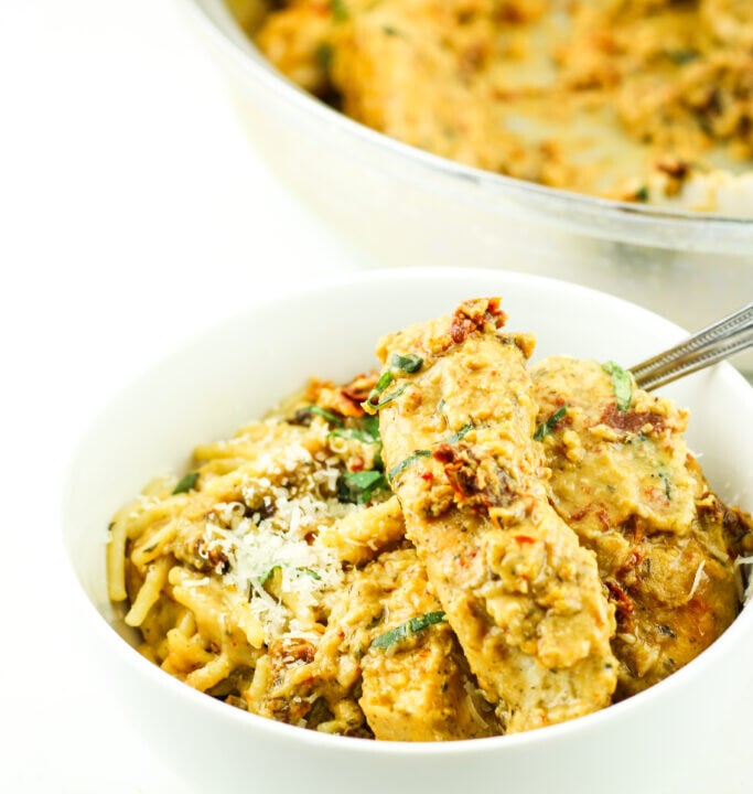 bowl of curry chicken with the baking pan behind it.