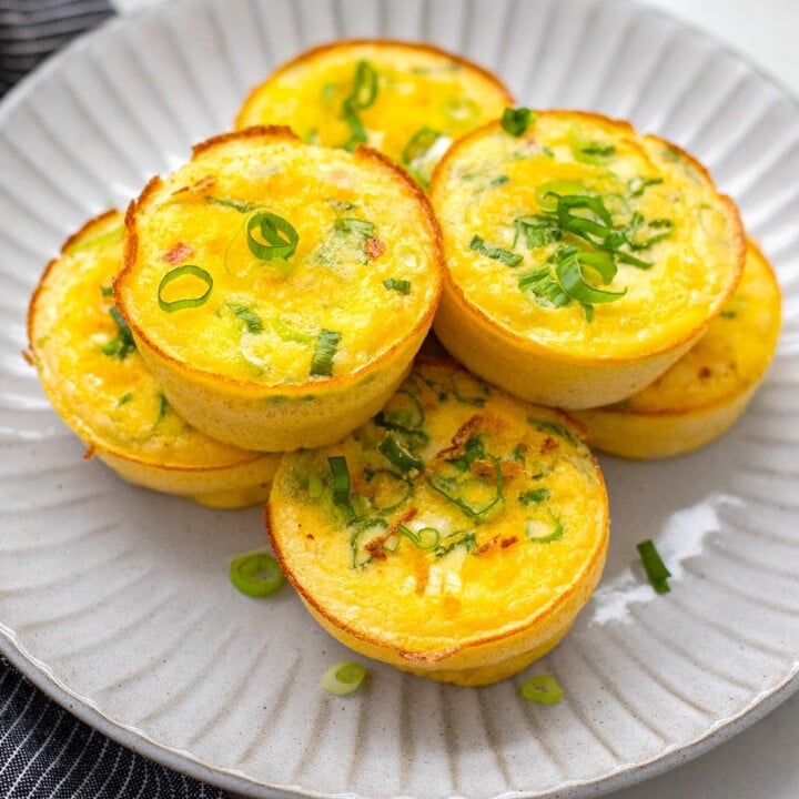 plate of egg bites with scallions on them.