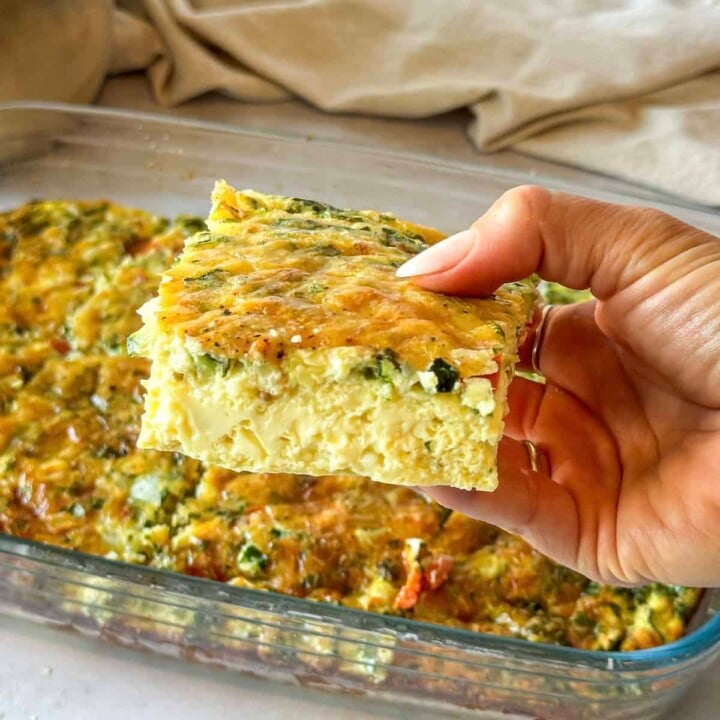 piece of egg bake being pulled from the pan.