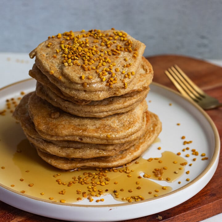 stack of golden brown pancakes with syrup.