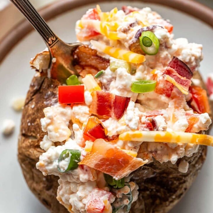 baked potato loaded with cottage cheese and veggies.