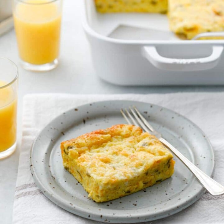 a piece of egg bake on a plate with a fork.