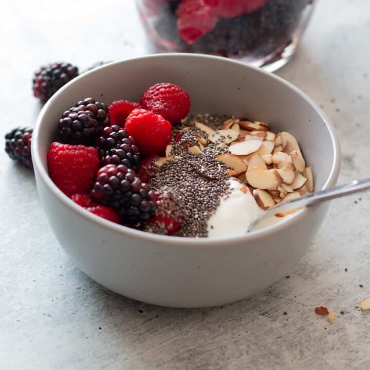 bowl with cottage cheese, fruit, and almonds.