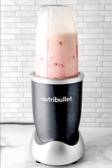 blender mixing the strawberry protein shake.
