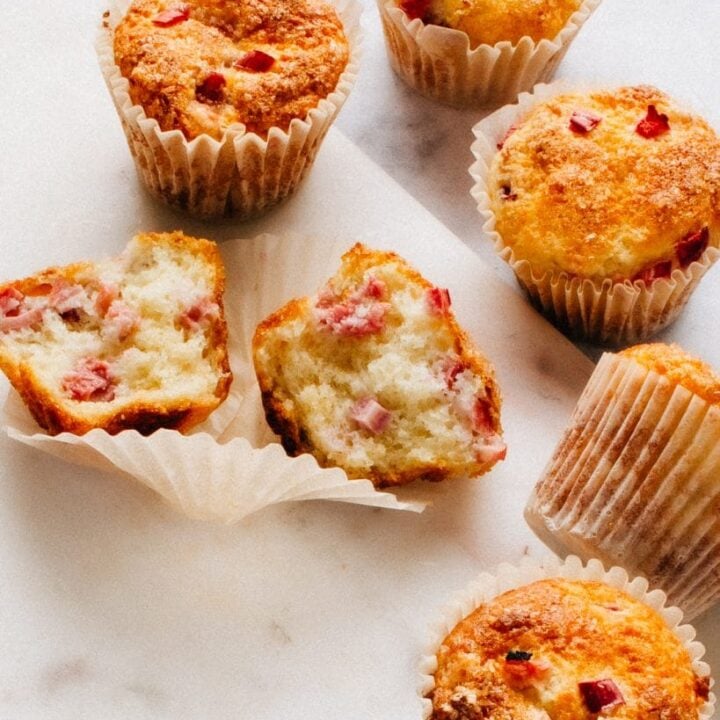 rhubarb protein muffins on a marble slab.
