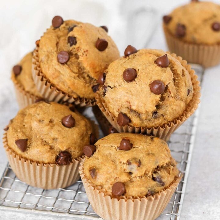chocolate chip protein banana muffins on a small cooling rack.