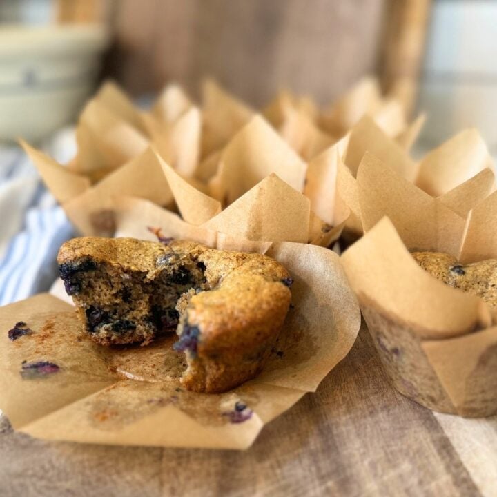 sourdough blueberry protein muffins in parchment wrappers.