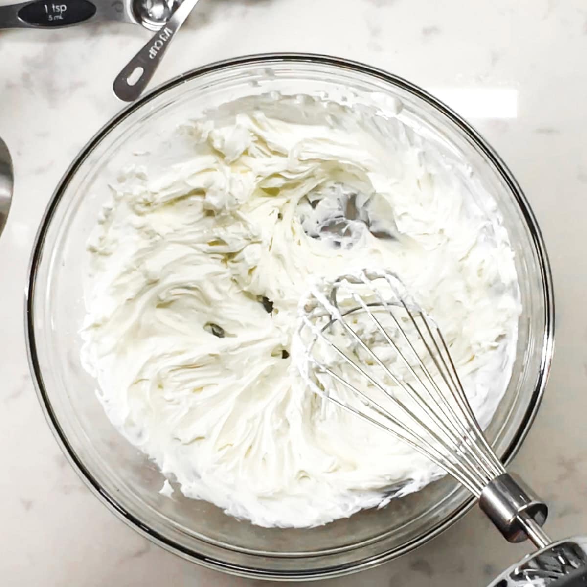 Neufchatel and Greek yogurt mixed in a glass bowl.