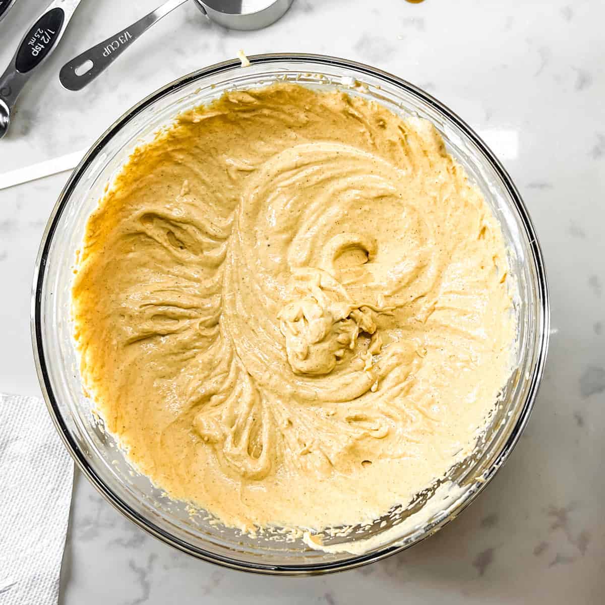 pumpkin cheesecake mousse with protein mixed in a glass bowl.