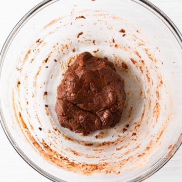 chocolate protein cookie dough in a glass bowl.