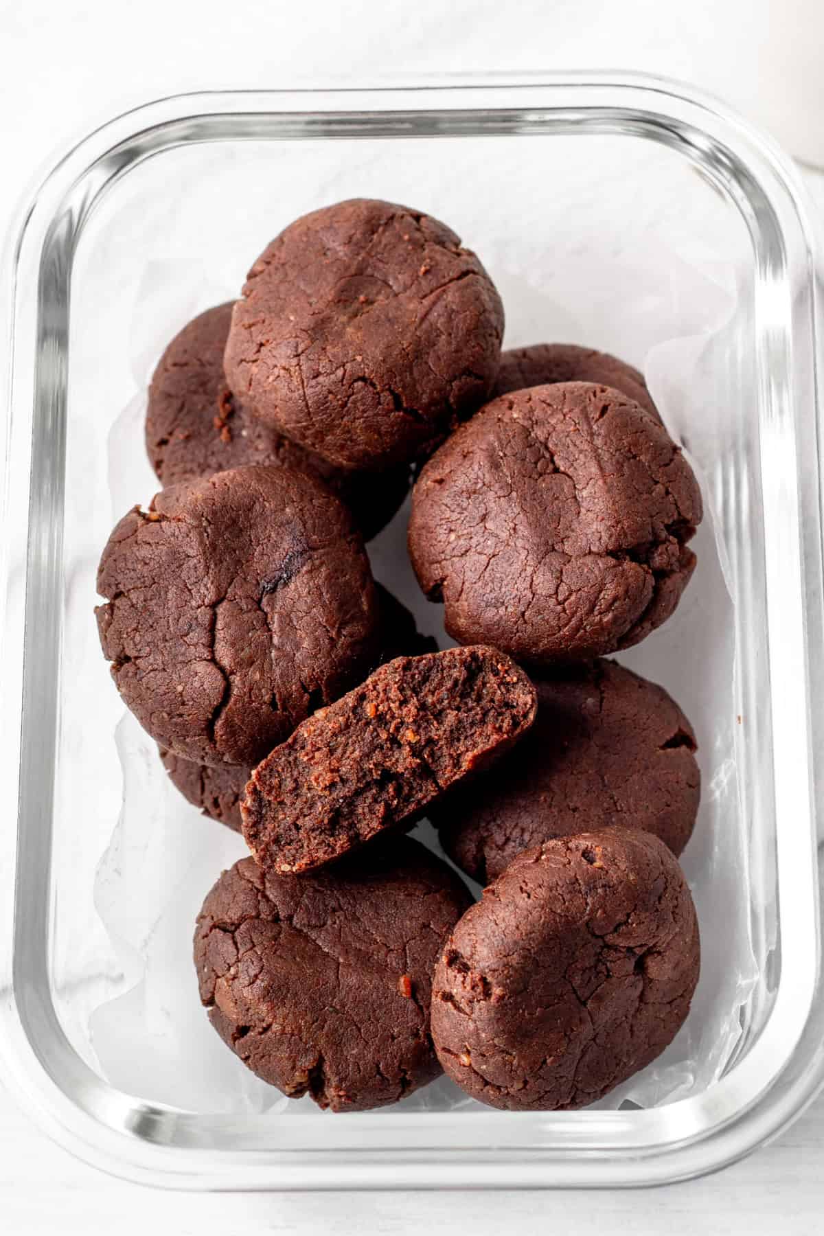 chewy chocolate protein cookies in a glass meal prep container.