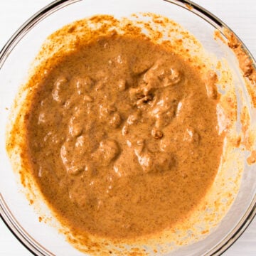 almond butter and water mixed together in a glass bowl.